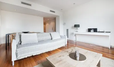 a living room with a couch and a coffee table at You Stylish City Center Apartments in Barcelona