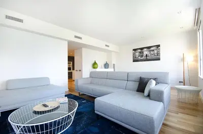 a living room with a couch and a table at You Stylish City Center Apartments in Barcelona