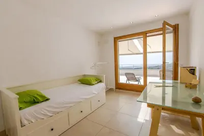 a bedroom with a bed and a glass table at Catalunya Casas Modern Magnificence , only a few km to the beach! in Sant Cebrià de Vallalta