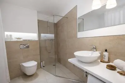 a bathroom with a toilet and a sink and a shower at Catalunya Casas Modern Magnificence , only a few km to the beach! in Sant Cebrià de Vallalta