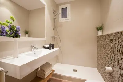 a white bathroom with a sink and a shower at Bcngotic in Barcelona