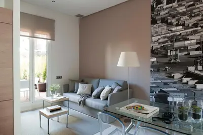 a kitchen with wooden cabinets and a table and chairs at Eric Vökel Boutique Apartments - Gran Vía Suites in Barcelona