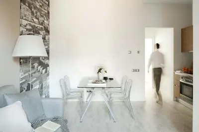 a white bedroom with a bed and a window at Eric Vökel Boutique Apartments - Gran Vía Suites in Barcelona