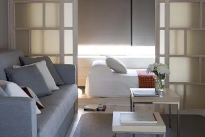 a bedroom with a large white bed with a window at Eric Vökel Boutique Apartments - Gran Vía Suites in Barcelona