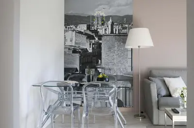 a living room with a staircase and a couch at Eric Vökel Boutique Apartments - Gran Vía Suites in Barcelona