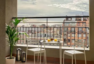a bedroom with a white bed and a large window at Eric Vökel Boutique Apartments - Gran Vía Suites in Barcelona