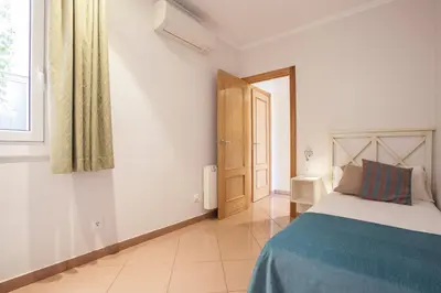 a bedroom with a bed and a window and a door at BCNGOTIC 22 in Barcelona