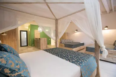 a bedroom with a bed with a canopy at La Bodega Suites in Hospitalet de Llobregat