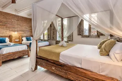 a bedroom with two beds and a window at La Bodega Suites in Hospitalet de Llobregat