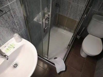 a bathroom with a sink and a shower and a toilet at Hostal Lesseps in Barcelona