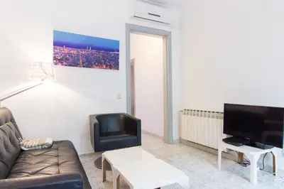 a living room with a couch and a tv at Charm Apartment Sagrada Familia in Barcelona
