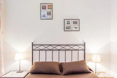 a bedroom with a bed with two lamps and two pictures on the wall at Charm Apartment Sagrada Familia in Barcelona