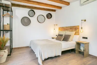 a bedroom with a bed and three clocks on the wall at KeyFamily Lovely Villa in Barcelona