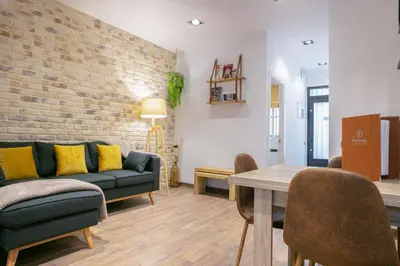 a living room with a couch and a table at KeyFamily Lovely Villa in Barcelona