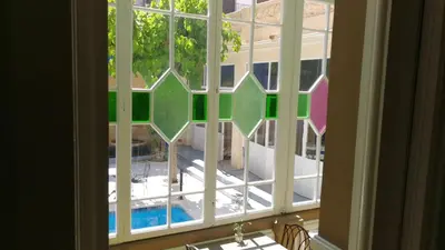 an open window with a view of a yard at Hotel El Xalet in Sitges