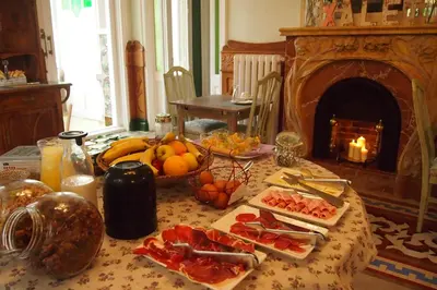 a table with food on it with a fireplace at Hotel El Xalet in Sitges
