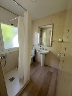 a bathroom with a shower and a sink and a mirror at Hostal Casa Torrent in Canet de Mar