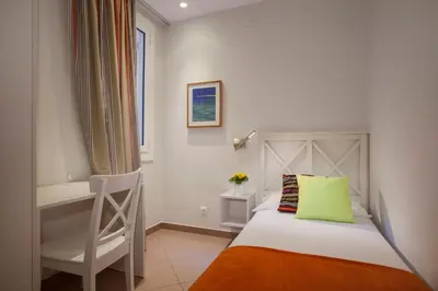 a bedroom with a bed with a chair and a desk at BCNGOTIC43 in Barcelona