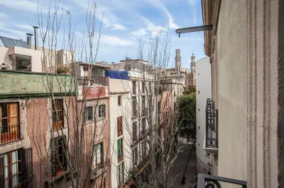 an alley in a city with tall buildings at BCNGOTIC43 in Barcelona