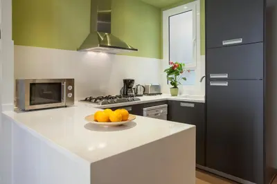 a kitchen with a bowl of oranges on a counter at BCNGOTIC43 in Barcelona