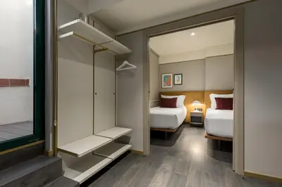 a hotel room with two beds and a mirror at Be Mate Paseo de Gracia in Barcelona
