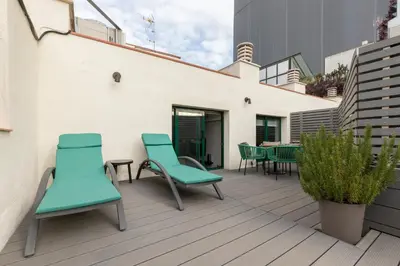 a patio with chairs and tables on a building at Be Mate Paseo de Gracia in Barcelona