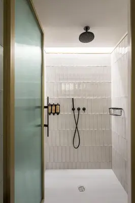 a bathroom with a shower with white tiles at Be Mate Paseo de Gracia in Barcelona