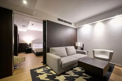 a living room with a couch and a bed at Catalonia Rigoletto in Barcelona