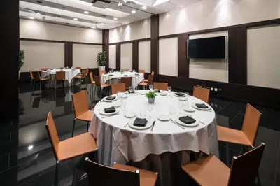 a conference room with tables and chairs and a tv at Catalonia Rigoletto in Barcelona