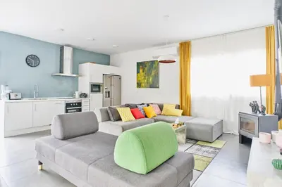 a living room with a couch and a kitchen at Jewel Home in Sant Pere de Ribes