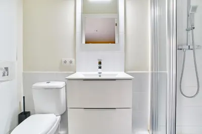 a bathroom with a toilet and a sink and a shower at Jewel Home in Sant Pere de Ribes