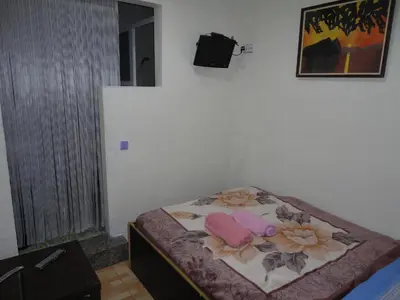 a small bedroom with a bed with flowers on it at Central Station Hostel Barcelona in Barcelona