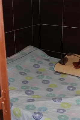 a bed with a flower pattern on it in a bathroom at Central Station Hostel Barcelona in Barcelona