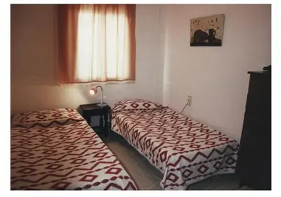 a room with two beds and a window at Mar De Cunit in Cunit