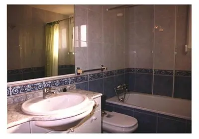 a bathroom with a sink and a toilet and a mirror at Mar De Cunit in Cunit