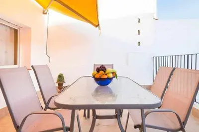 a dining room table with a bowl of fruit on it at Sitges Malvasia · Paz en el Corazón de Sitges in Sitges