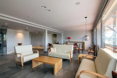 a living room with white furniture and a table at Hotel Restaurant Sol i Vi in Lavern