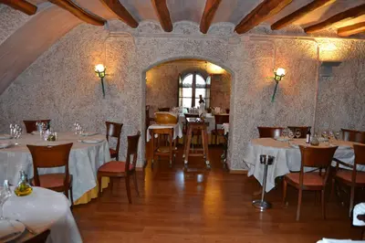 a restaurant with white tables and chairs and a window at Hotel Restaurant Sol i Vi in Lavern