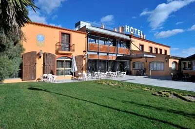 a hotel with a lawn in front of it at Hotel Restaurant Sol i Vi in Lavern