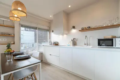 a kitchen with white cabinets and a counter top at Gava Ocean View in Gavà