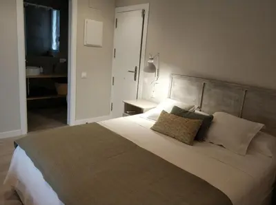 a bedroom with a large white bed with two pillows at Gava Ocean View in Gavà