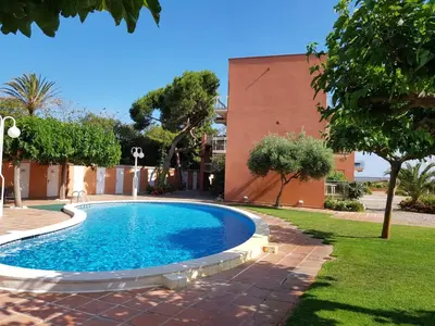 a swimming pool in a yard next to a building at Gava Ocean View in Gavà