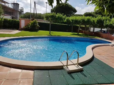 a small pool with a chair in a yard at Gava Ocean View in Gavà