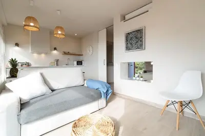 a living room with a white couch and a table at Gava Ocean View in Gavà