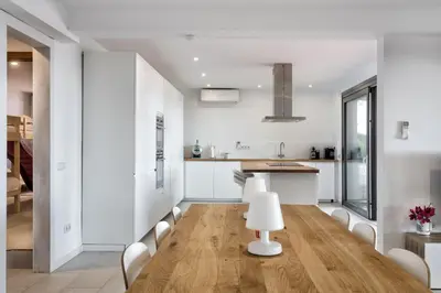 a kitchen and dining room with a table and chairs at Villa Costa Barcelona in Arenys de Munt