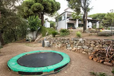 a large trampoline in front of a house at Villa Costa Barcelona in Arenys de Munt
