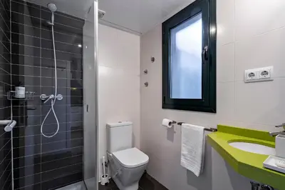 a bathroom with a toilet and a sink and a shower at Verdi Habitat Apartments in Barcelona