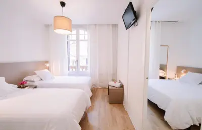a hotel room with two beds and a television at Hostalet de Barcelona in Barcelona