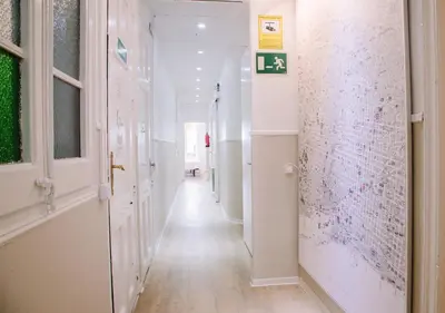 a hallway with white walls and a long hallway at Hostalet de Barcelona in Barcelona