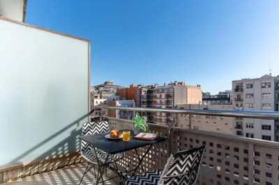 a table and chairs on a balcony with a view at TSA Sepulveda in Barcelona